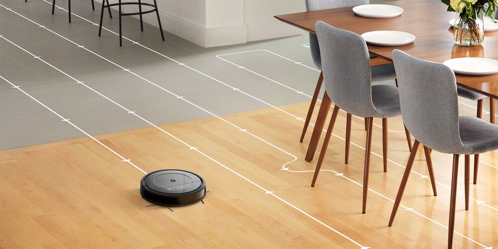 Een Roomba die een hardhouten vloer schoonmaakt