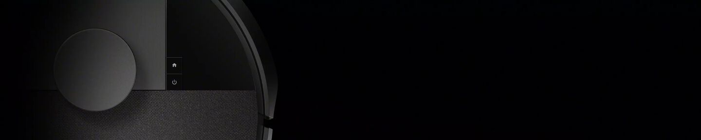 Een afbeelding van een Roomba robotstofzuiger tegen een dramatische zwarte achtergrond.